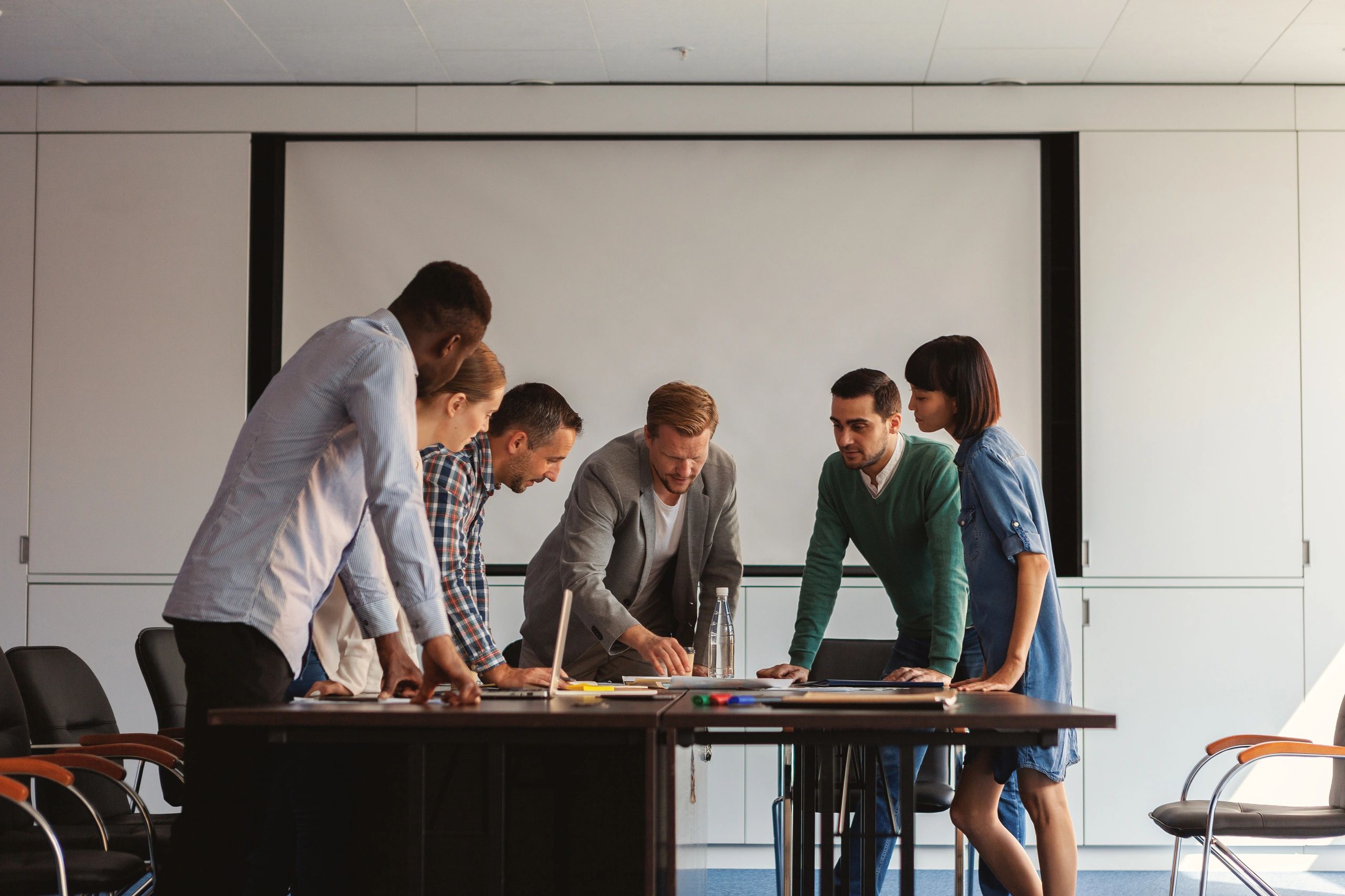 Business team reviewing plans together around a table