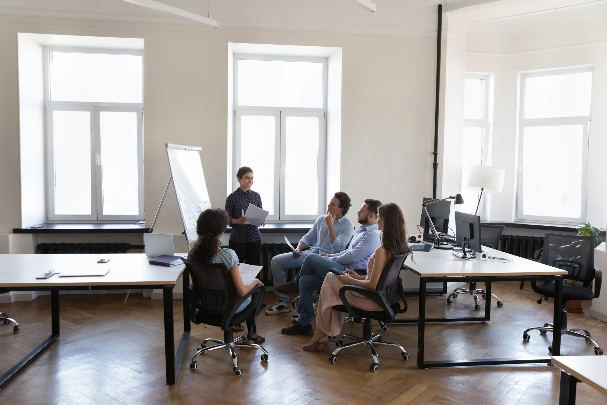 Presenter leading a project management training session with a business team